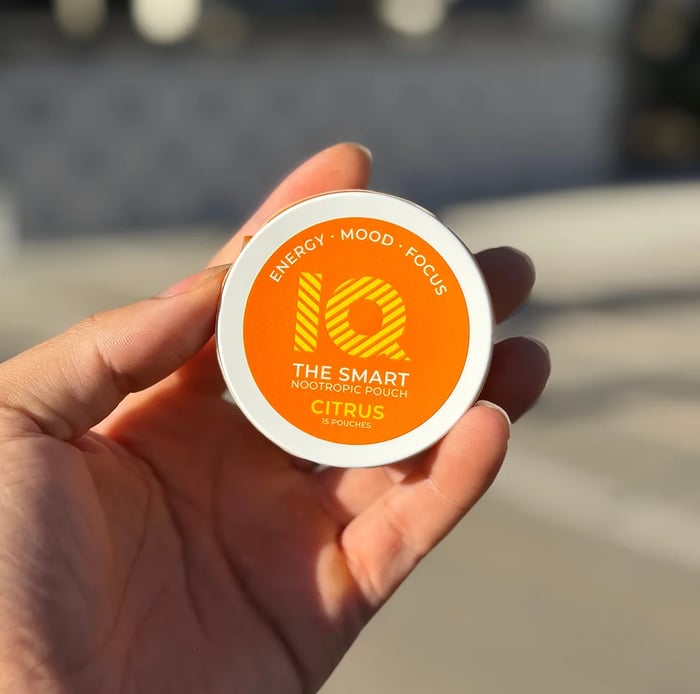 Holding an IQ Pouch Citrus tin