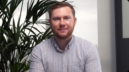 QT Funded trader interview still — funded trader at his desk